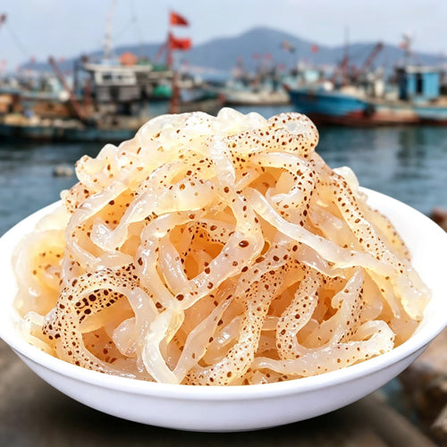 Bowl of translucent salted jellyfish strips with the harbour behind