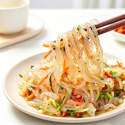 Jellyfish strip salad lifted with chopsticks